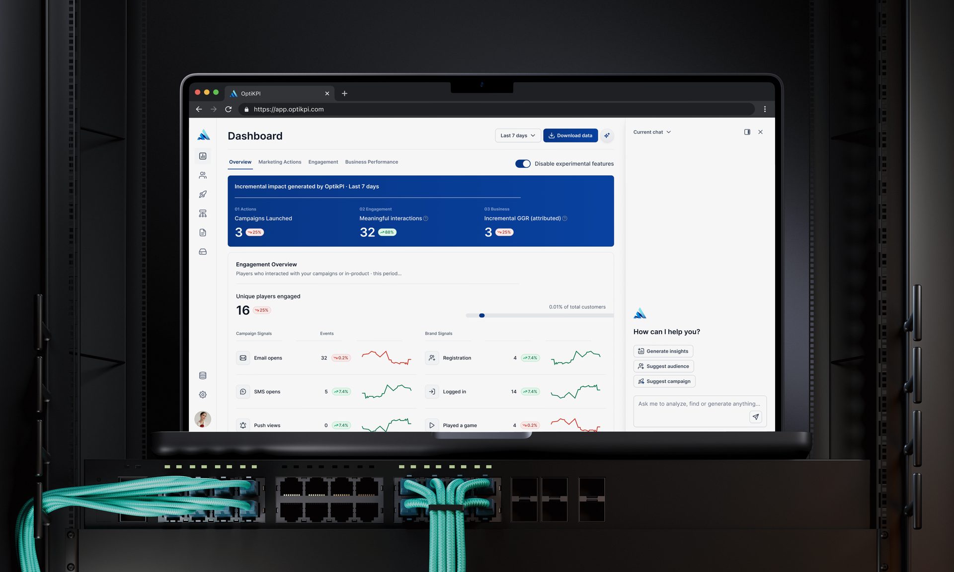 The OptiKPI 2.0 dashboard open in a browser on a laptop standing in a server rack.